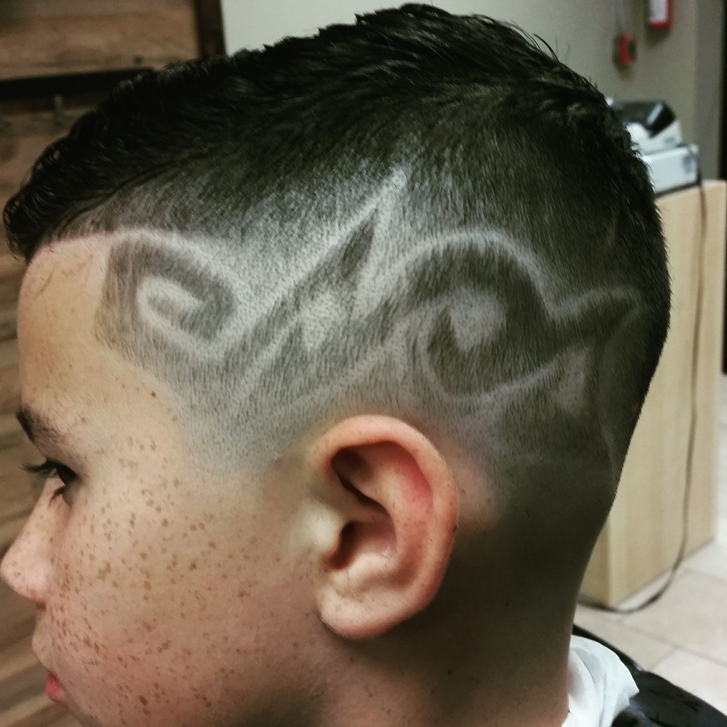 close-up of a custom haircut design at Atomic Salon