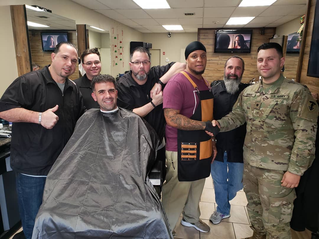 group picture with barbers and clients, including Scott at Atomic Salon